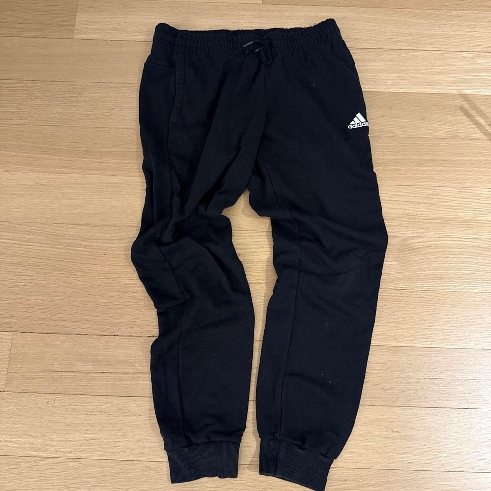 Black Adidas joggers with drawstring waist and tapered fit